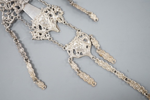 An Edwardian silver chatelaine, pierced and decorated with masks and scrolls, Nathan & Hayes, Chester, 1903, 21.6cm, 78 grams.